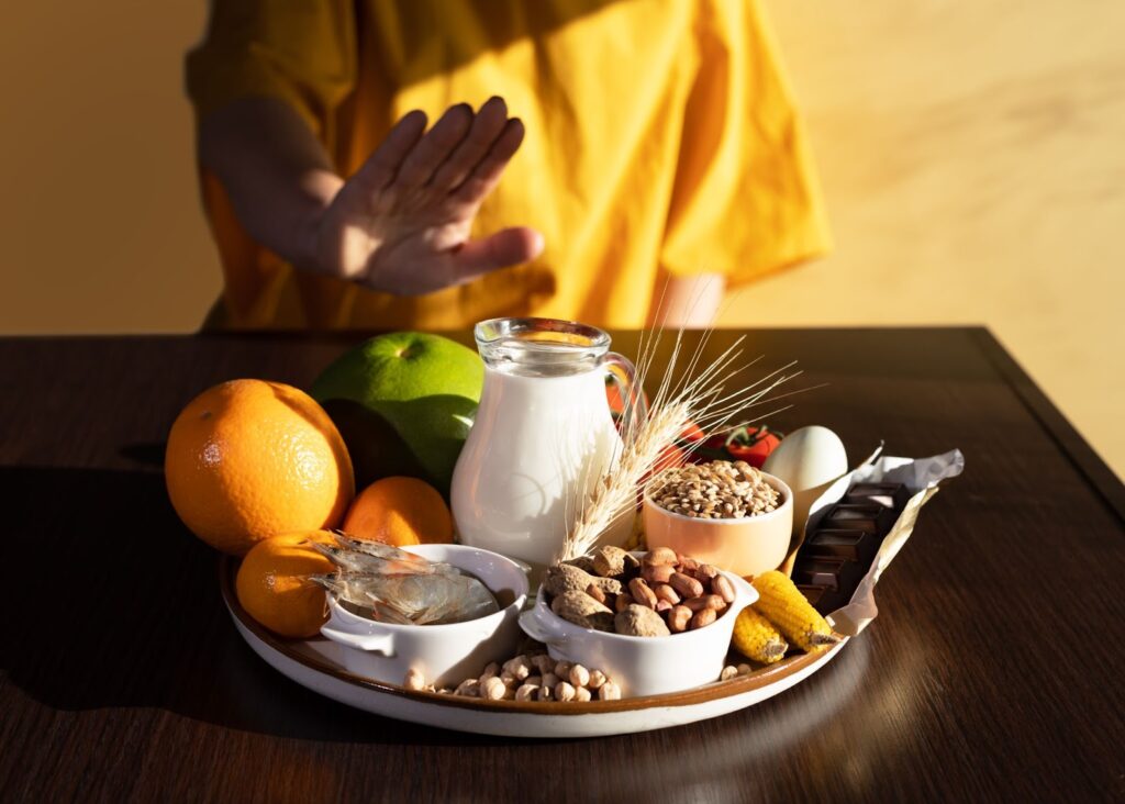A person holding a plate with a variety of food. Food sensitivity, sensitivities to food, Food Sensitivity Testing.