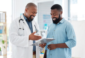 A man and a doctor having a conversation in a medical office.