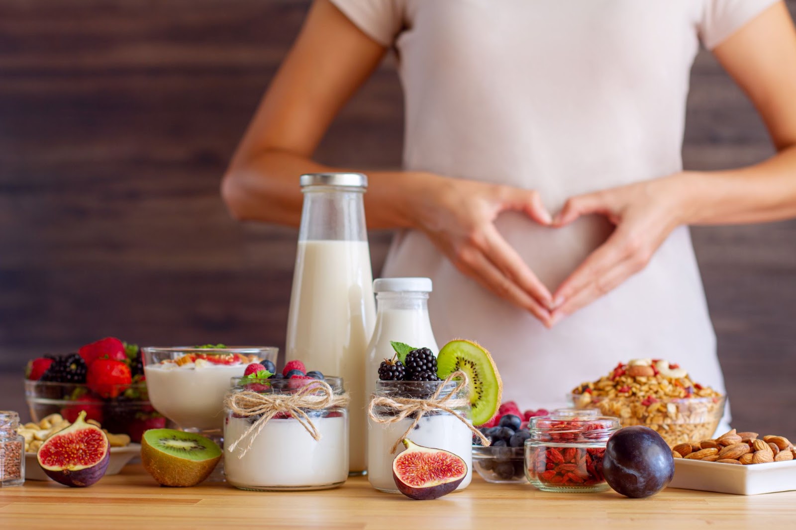 A vibrant breakfast bowl with yogurt,granola,berries, kiwi,almonds,and figs,promoting healthy eating and wellness.