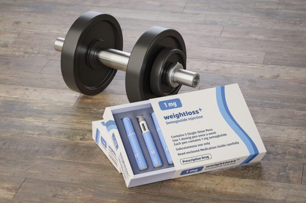 A box of weightlifting equipment on a wooden floor showing various weights and accessories