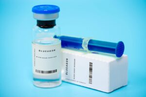 A vial of blood placed beside a closed box indicating a medical or laboratory context